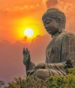 statue of Buddha with sunset in background
