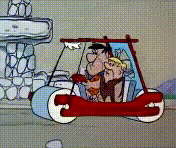 Los Flintstones conduciendo un automóvil.